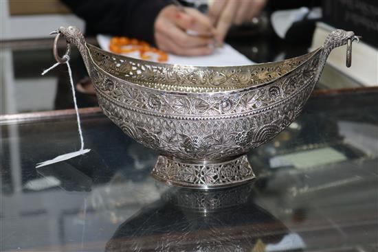 An Indian? white metal oval bowl with ring handles and three other items including two filligree items.